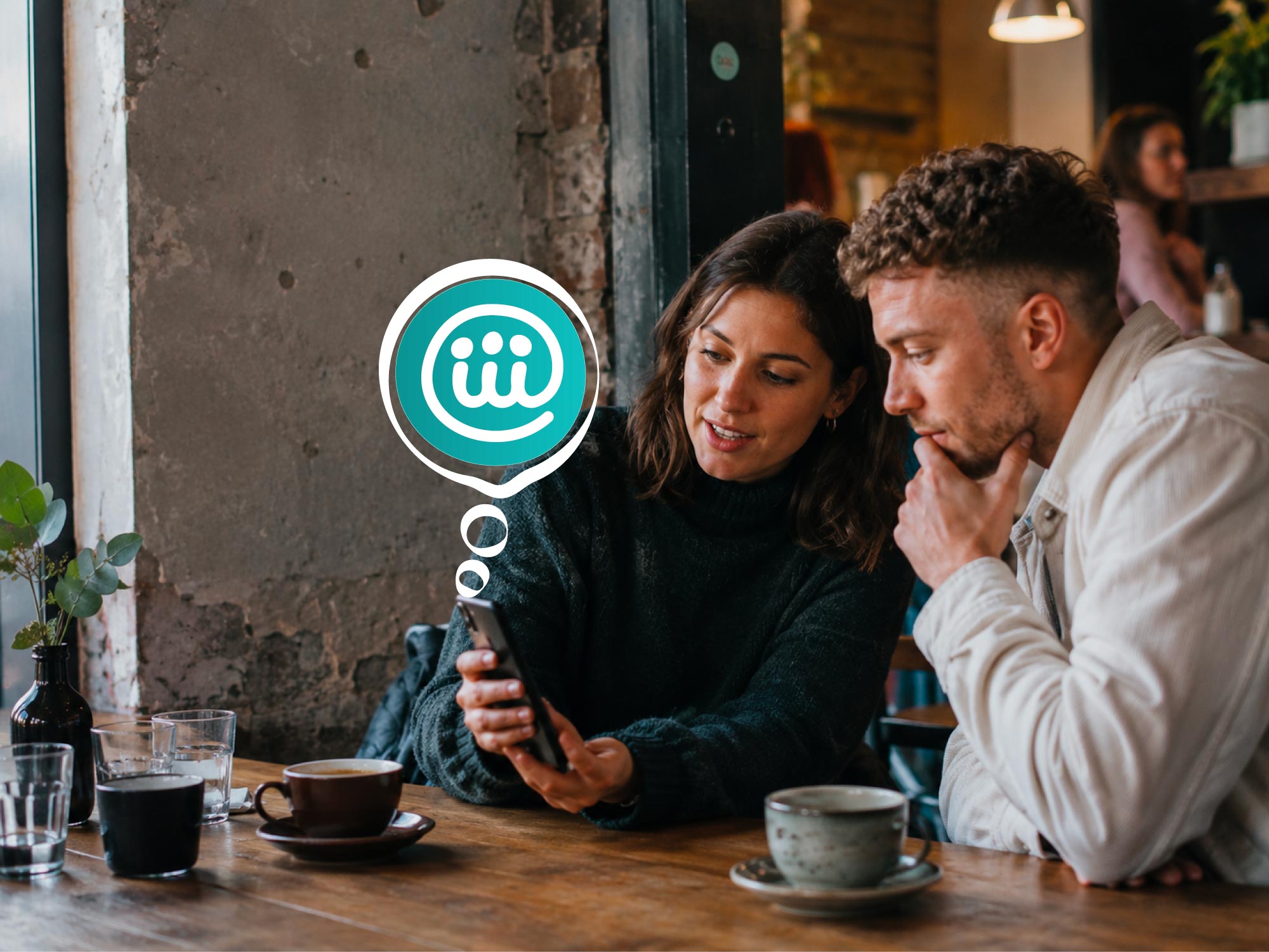 Two people looking together at a job role on a phone